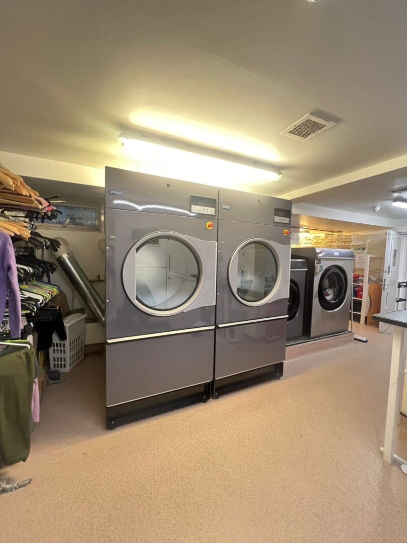 Laundry room with industrial washing machines.