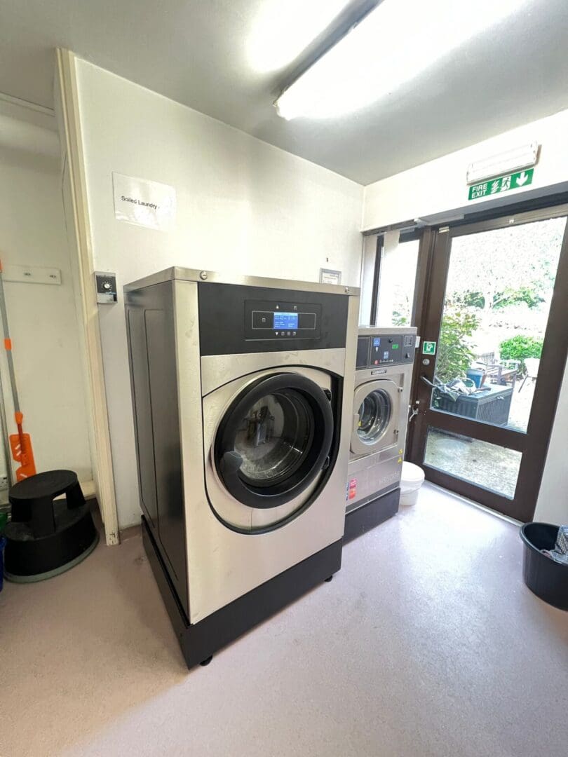 Laundry room with two washing machines.