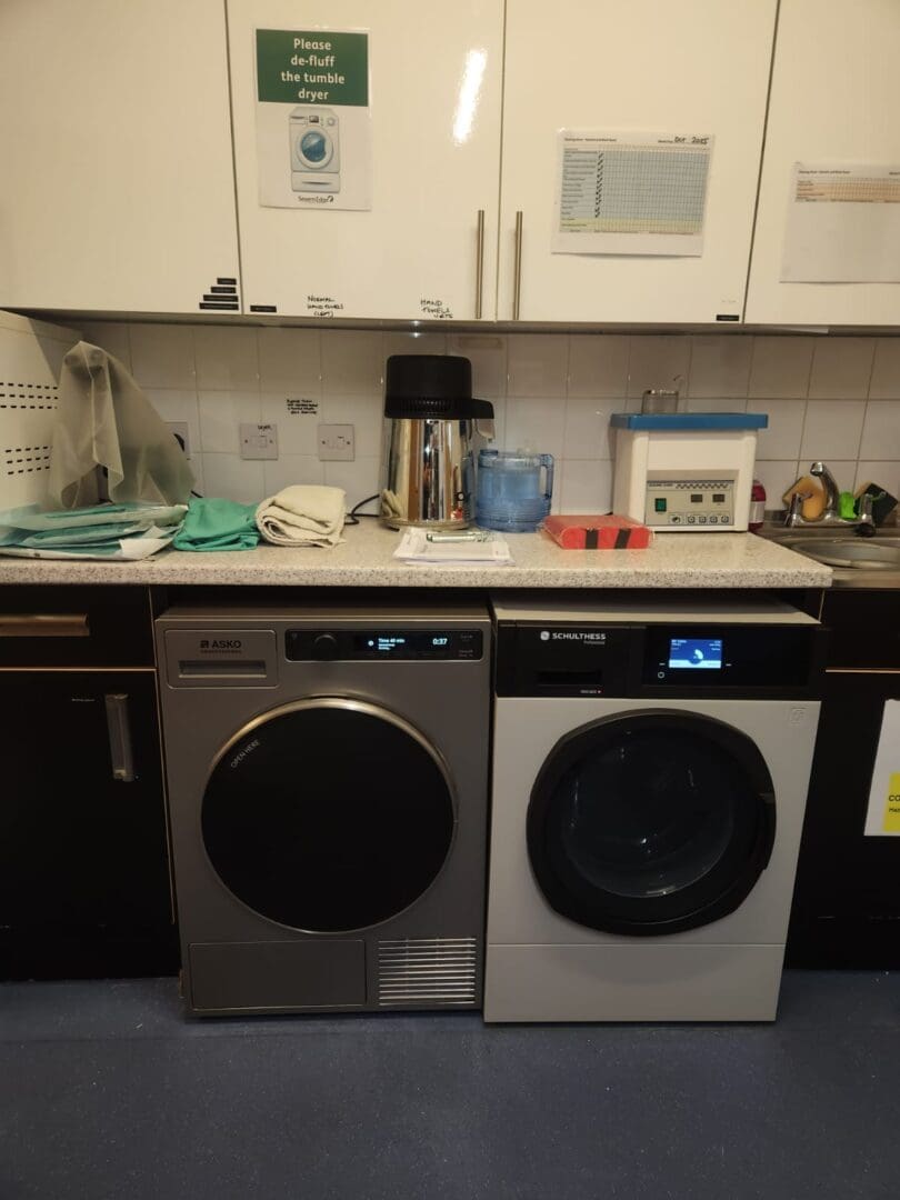Laundry room with two washing machines.