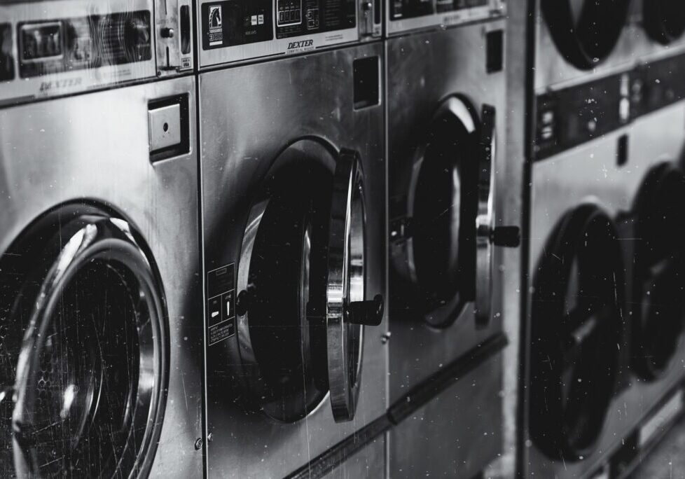 Close-up of washing machines in a laundromat.