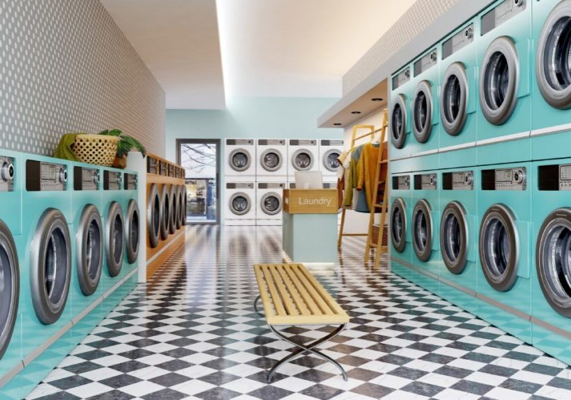 Retro laundromat with teal washing machines.